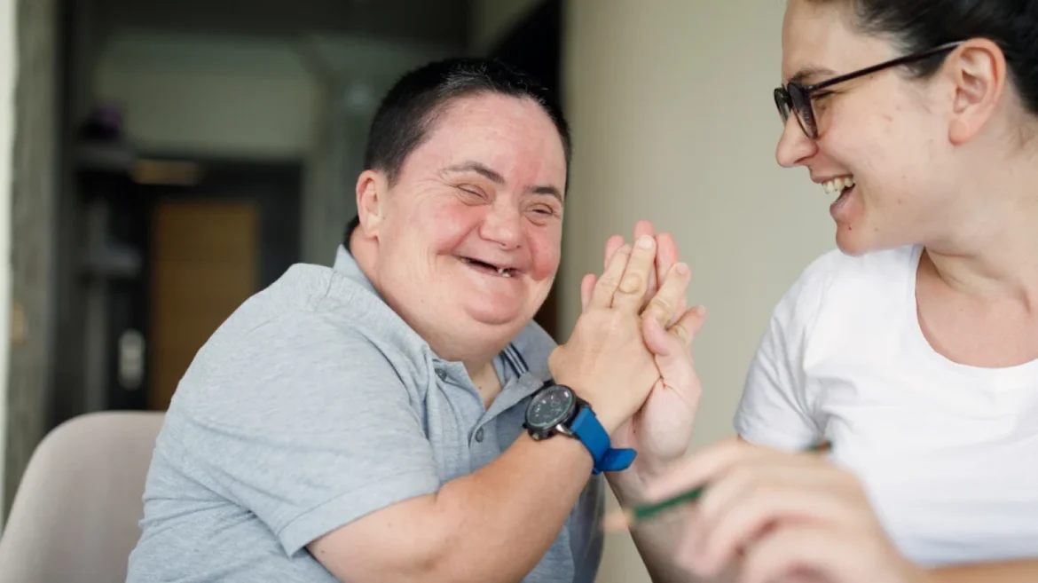 Supported housing with Down syndrome smiling
