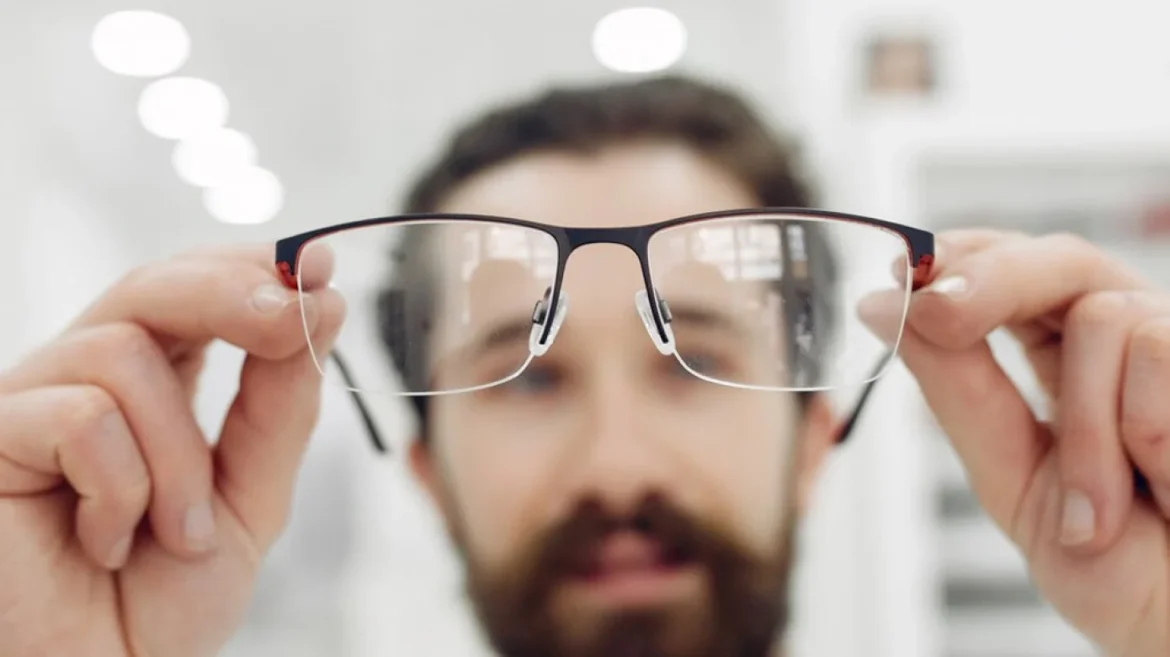 Man holding eyeglasses