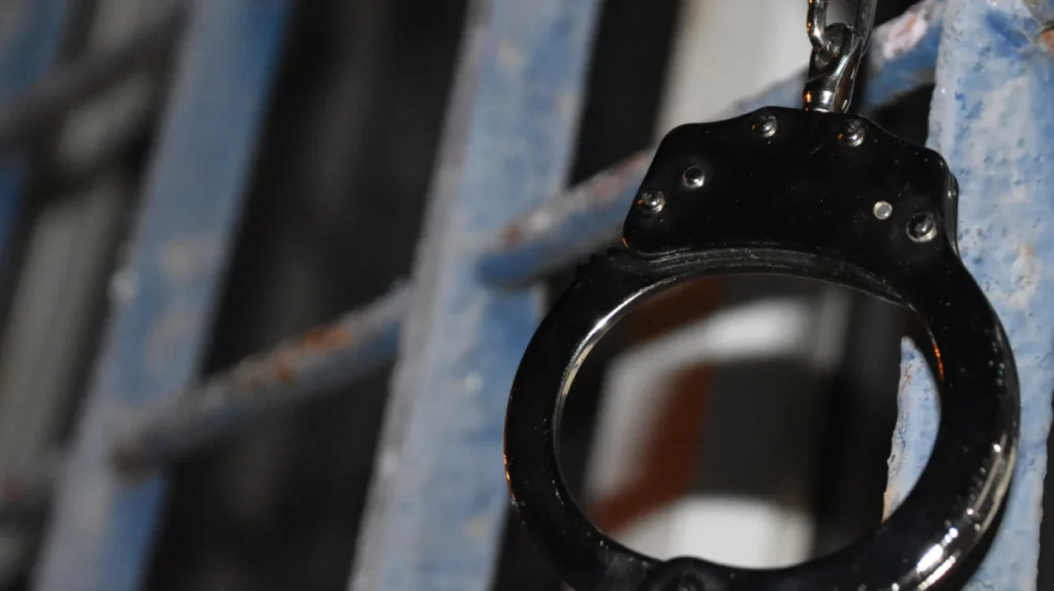 Handcuffs on jail bars