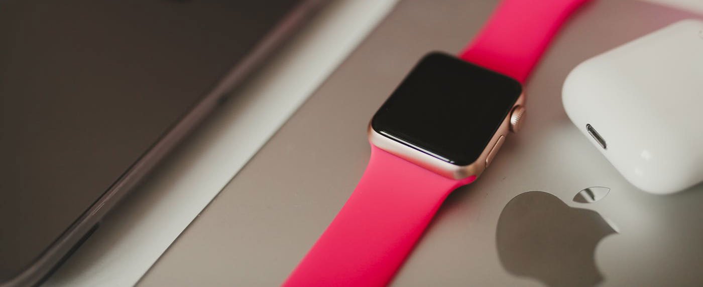 Apple Watch with pink band and AirPods showcasing iPhone 17 Series accessories ecosystem