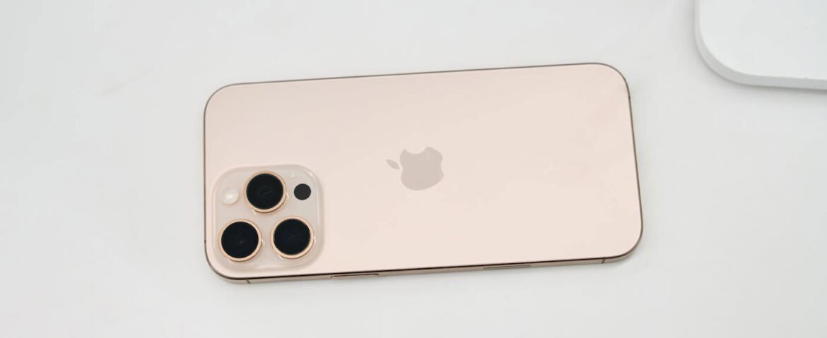Silver iPhone 17 Pro from the iPhone 17 Series showing the triple-lens plateau camera system on a white surface.